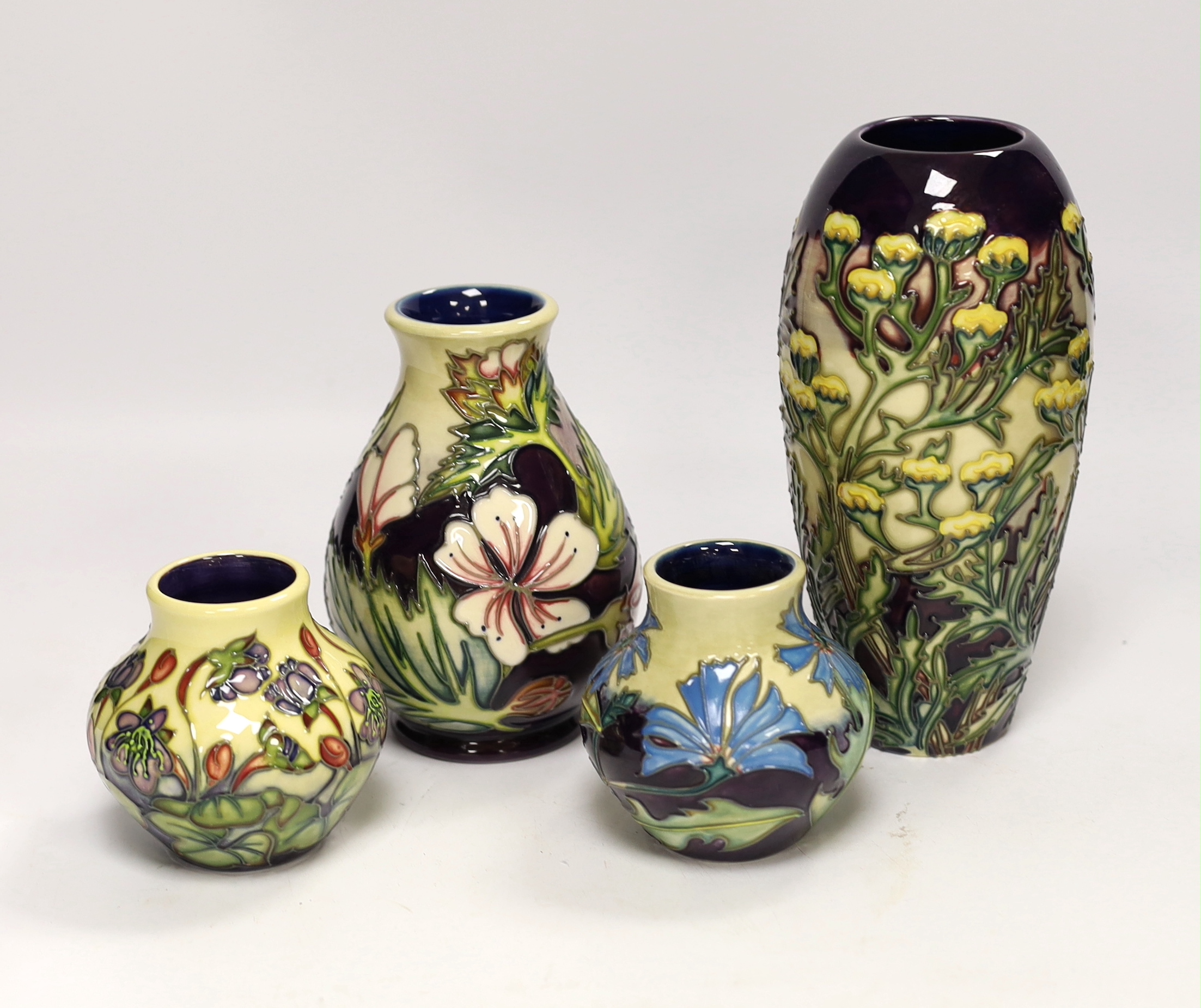 Two squat Moorcroft vases and two larger vases, tallest 19cm high